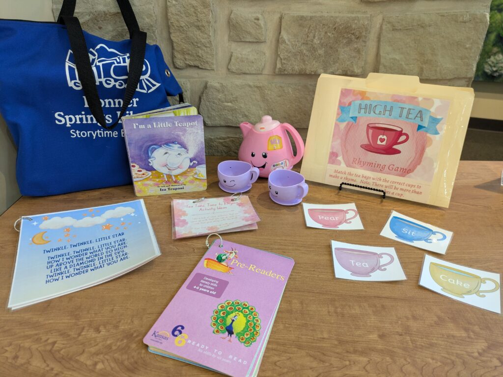 Kit containing tea set, book, folder with information for parents, and with 6 by 6 brochures.